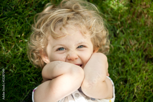 Photo: Adorable little girl taken closeup outdoors in summer Adorable little girl taken closeup outdoors in summer