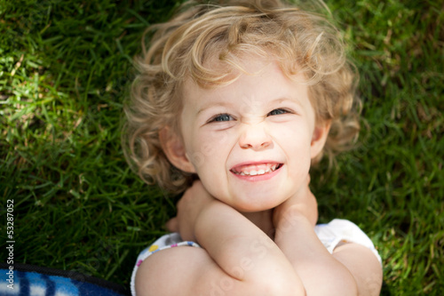 Photo: Adorable little girl taken closeup outdoors in summer Adorable little girl taken closeup outdoors in summer