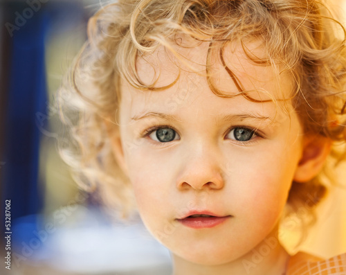 Photo: Adorable little girl taken closeup outdoors in summer Adorable little girl taken closeup outdoors in summer