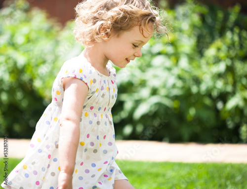Photo: Adorable little girl taken closeup outdoors in summer Adorable little girl taken closeup outdoors in summer