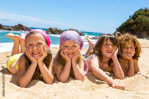 Photo: Kids laying on the beach. Kids laying on the beach.