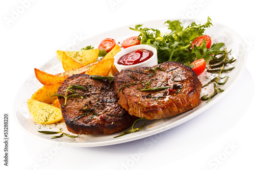 Photo: Grilled steaks, baked potatoes and vegetables Grilled steaks, baked potatoes and vegetables