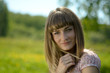 Beautiful young woman portrait in a green park