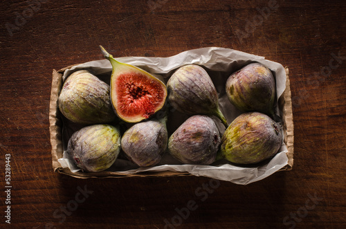 Photo: Figs in the box on wooden table Figs in the box on wooden table