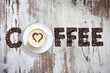 Cup of coffee with letters beans on vintage retro boards