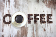 Cup of coffee with  letters beans on vintage retro boards