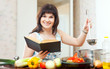  positive housewife cooking with book