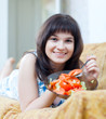 positive casual woman eats tomatoes salad