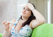 Sad young woman having temperature