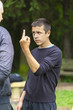 Boy showing middle finger to adult