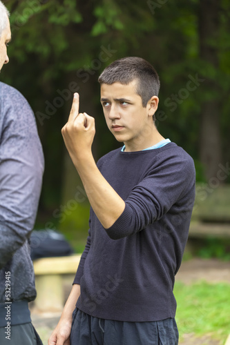 Photo: Boy showing middle finger to adult Boy showing middle finger to adult