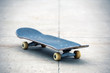 Old used skateboard isolated on the ground. Shallow dof.