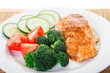 Vegetables with Baked Salmon on a White Plate