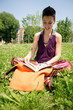 beautiful hipster short hair woman reading book in the park