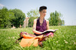 beautiful hipster short hair woman reading book in the park