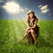 Photo: woman traveler sitting on suitcase outdoor woman traveler sitting on suitcase outdoor