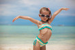 little girl on her stomach painted a smile by sun cream