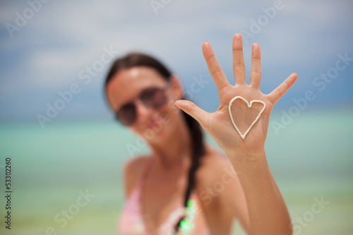 Photo: Close-up of girl's hand with heart on the palm painted by Close-up of girl's hand with heart on the palm painted by