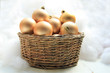Golden Christmas ornaments in a wicker basket