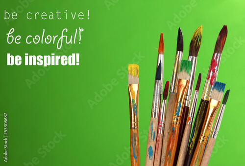 Photo: Many brush in paint on green background Many brush in paint on green background