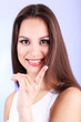 Young woman putting contact lens in her eye close up
