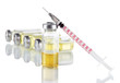Medical bottles and syringe on light gray background
