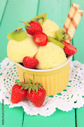 Photo: Delicious ice cream with fruits and berries in bowl Delicious ice cream with fruits and berries in bowl