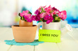 Photo: Flowers growing from egg shell, on bright background Flowers growing from egg shell, on bright background