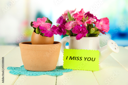 Photo: Flowers growing from egg shell, on bright background Flowers growing from egg shell, on bright background