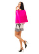 Smiling young girl with bags talks by mobile phone