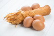 Photo: Braided cheese and raw chicken eggs, horizontal shot Braided cheese and raw chicken eggs, horizontal shot