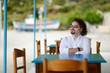 Young man relaxing in outdoor restaurant