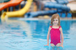 Adorable little girl having fun in a swimming pool