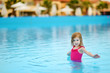 Adorable little girl having fun in a swimming pool