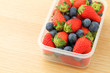 Strawberry and blueberry mix in plastic container
