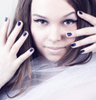 young woman portrait with colorful makeup and nail polish