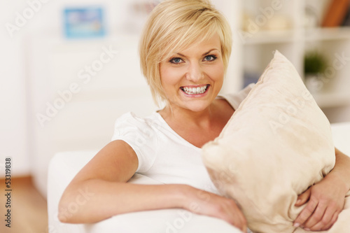 Photo: Happy woman hugging pillow and resting at home Happy woman hugging pillow and resting at home
