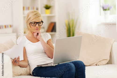 Photo: Young blonde woman working at home Young blonde woman working at home