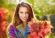 Photo: Portrait of beautiful young woman in autumn park. Portrait of beautiful young woman in autumn park.