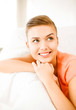Foto: smiling woman lying on the couch smiling woman lying on the couch