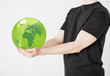 man holding green sphere globe