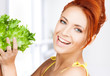 woman holding lettuce
