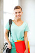 Photo: student girl with school bag and color folders student girl with school bag and color folders