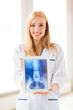 female doctor with x-ray on tablet pc
