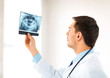 male doctor or dentist looking at x-ray