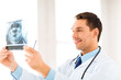 male doctor or dentist with x-ray