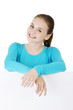 Photo: Portrait young happy woman with blank board Portrait young happy woman with blank board