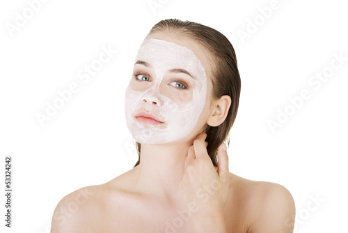 Photo: Beautiful woman with clay facial mask Beautiful woman with clay facial mask
