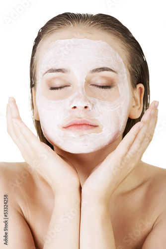 Photo: Beautiful woman with clay facial mask Beautiful woman with clay facial mask