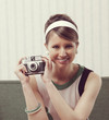 Foto: Retro woman with old-fashioned camera Retro woman with old-fashioned camera